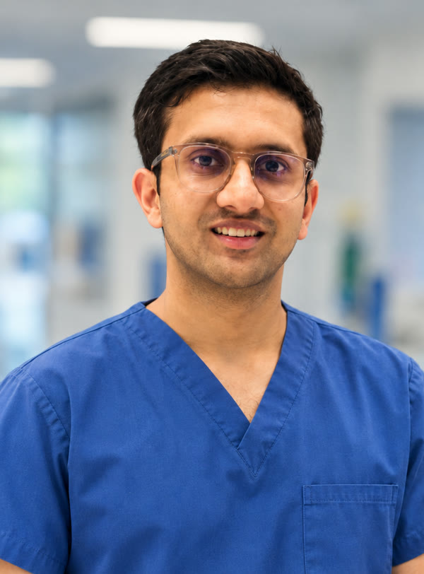 Dr. Prabhat Saharia in blue surgical scrubs